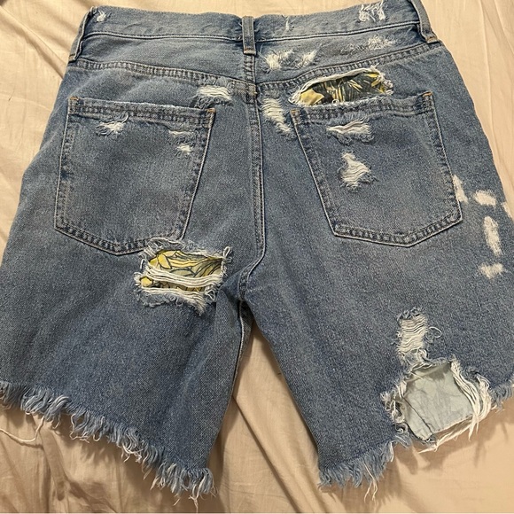 We the Free denim shorts. Frayed hem with floral details in distressed areas. - Picture 2 of 5